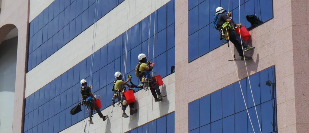 NEAS rope access technicians on glass skyscraper facade